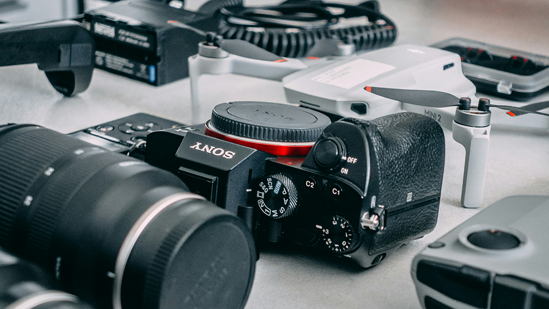 Camera and drone equipment laid out on a desk